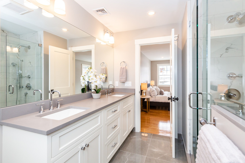 Bathroom - mid-sized contemporary 3/4 white tile and ceramic tile porcelain tile and multicolored floor bathroom idea in Boston with recessed-panel cabinets, a one-piece toilet, gray walls, an undermount sink, quartz countertops, white cabinets and gray countertops