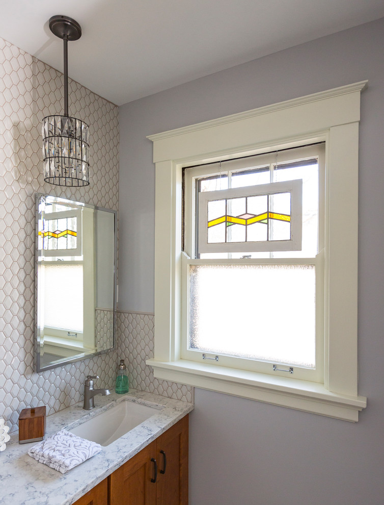 Inspiration for a small craftsman master white tile and porcelain tile porcelain tile and gray floor alcove shower remodel in Cincinnati with flat-panel cabinets, medium tone wood cabinets, a one-piece toilet, white walls, an undermount sink, quartzite countertops and a hinged shower door