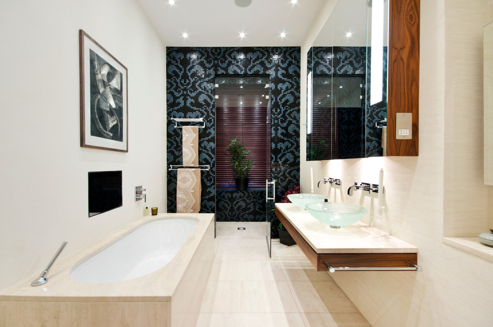 Inspiration for a contemporary beige tile and ceramic tile bathroom remodel in London with a vessel sink, an undermount tub and white walls