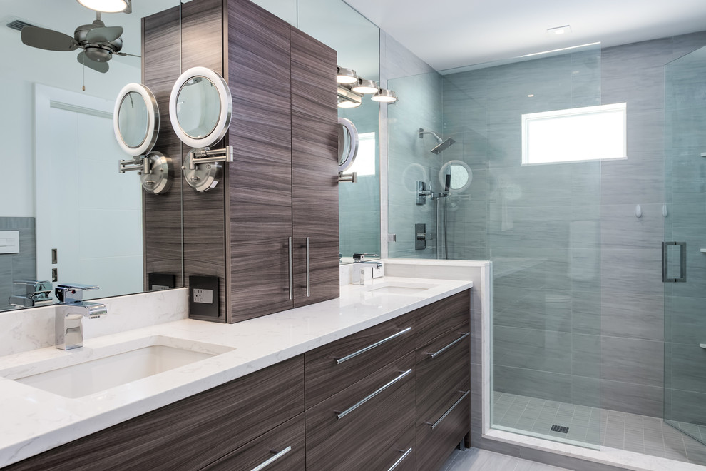 Design ideas for a medium sized contemporary ensuite bathroom in Miami with flat-panel cabinets, grey tiles, porcelain tiles, a submerged sink, engineered stone worktops, dark wood cabinets, an alcove shower, grey walls and a hinged door.