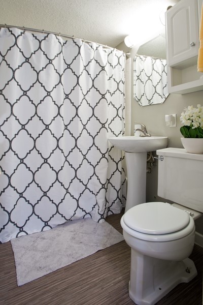 Bathroom - small modern master white tile and ceramic tile vinyl floor bathroom idea in Kansas City with white cabinets, a one-piece toilet, gray walls, a pedestal sink and glass countertops