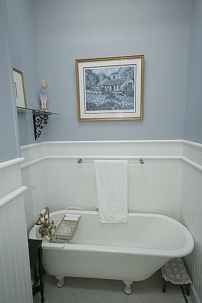Example of a classic white tile and porcelain tile bathroom design in New York with a two-piece toilet