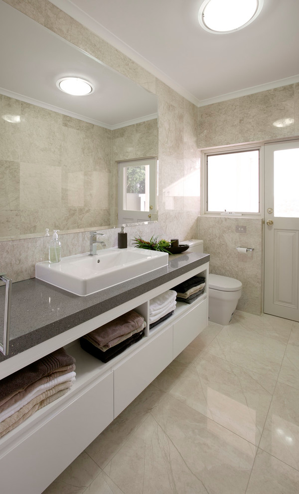 Ispirazione per una stanza da bagno design con lavabo da incasso, ante lisce, ante beige, piastrelle beige, pareti beige e pavimento beige