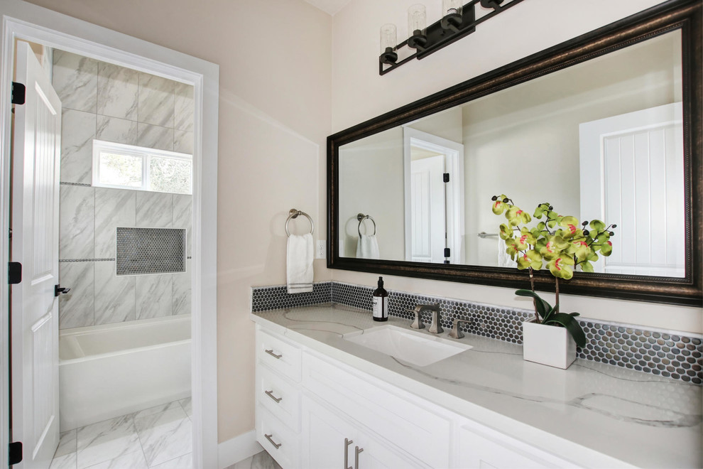 Inspiration for a mid-sized timeless 3/4 mosaic tile double-sink bathroom remodel in Sacramento with shaker cabinets, white cabinets, an undermount sink, quartzite countertops, white countertops and a built-in vanity