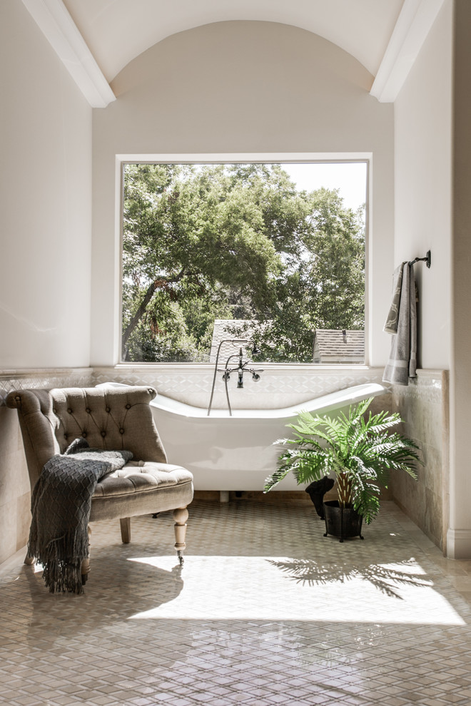 Inspiration for a large mediterranean ensuite bathroom in Dallas with a submerged sink, dark wood cabinets, a claw-foot bath, a double shower, a one-piece toilet and white walls.