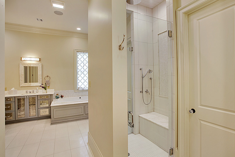 Medium sized farmhouse ensuite bathroom in New Orleans with freestanding cabinets, grey cabinets, a built-in bath, a double shower, white tiles, ceramic tiles, beige walls, ceramic flooring, a submerged sink and marble worktops.