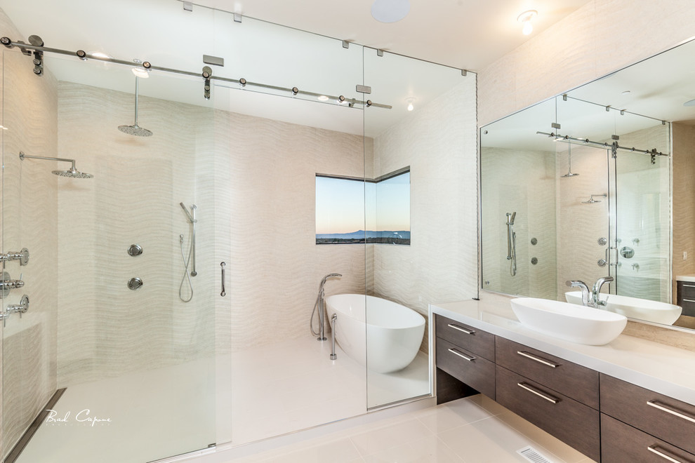 This is an example of a medium sized modern family bathroom in Salt Lake City with a vessel sink, flat-panel cabinets, white cabinets, onyx worktops, a freestanding bath, a walk-in shower, a one-piece toilet, white tiles, ceramic tiles, white walls and travertine flooring.