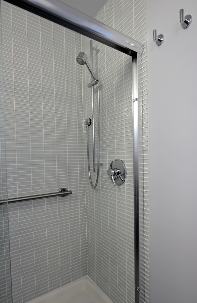 Example of a mid-sized trendy gray tile and glass tile porcelain tile alcove shower design in DC Metro with a vessel sink, flat-panel cabinets, a one-piece toilet, gray walls and medium tone wood cabinets