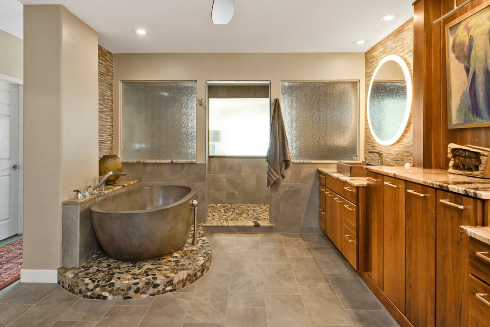 Exemple d'une douche en alcôve principale tendance en bois brun avec un placard à porte plane, une baignoire indépendante, un carrelage gris, un mur gris, une vasque, un sol gris, aucune cabine et un plan de toilette beige.