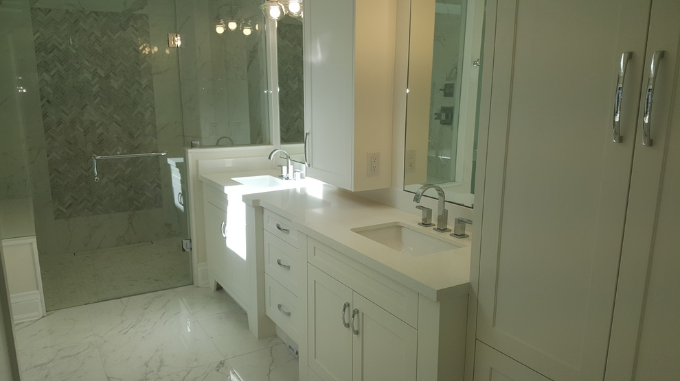 Inspiration for a large classic ensuite bathroom in Toronto with shaker cabinets, white cabinets, a freestanding bath, an alcove shower, white walls, marble flooring, a submerged sink, engineered stone worktops, white floors, a hinged door and white worktops.