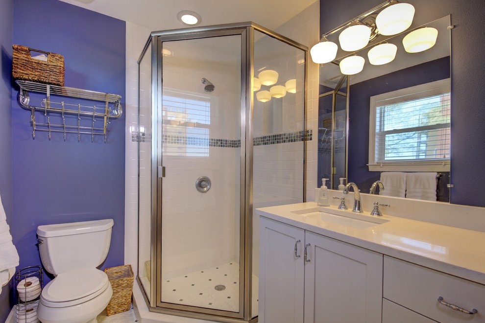 Medium sized beach style shower room bathroom in Tampa with shaker cabinets, white cabinets, a corner shower, a two-piece toilet, black and white tiles, ceramic tiles, purple walls, ceramic flooring, a submerged sink and solid surface worktops.