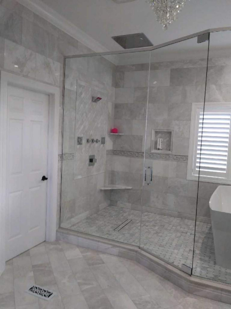 Large classic ensuite wet room bathroom in Boston with freestanding cabinets, white cabinets, a freestanding bath, grey tiles, marble tiles, grey walls, marble flooring, a submerged sink, marble worktops, grey floors, a hinged door and grey worktops.