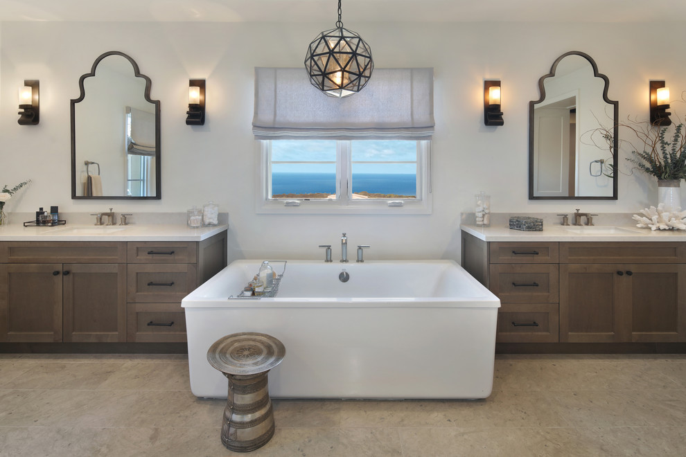 Inspiration for a huge mediterranean master white tile and stone slab limestone floor and gray floor bathroom remodel in Orange County with shaker cabinets, medium tone wood cabinets, white walls, a wall-mount sink, quartz countertops, a hinged shower door and white countertops