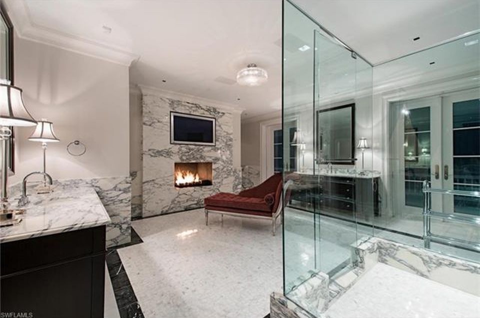 Klassisk inredning av ett en-suite badrum, med skåp i mörkt trä, marmorkakel, vita väggar, marmorgolv, marmorbänkskiva, vitt golv och dusch med gångjärnsdörr