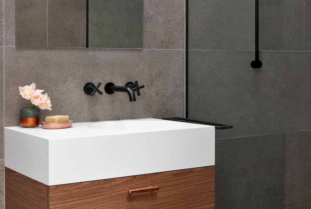 Small urban shower room bathroom in Melbourne with flat-panel cabinets, dark wood cabinets, a walk-in shower, a one-piece toilet, grey tiles, porcelain tiles, porcelain flooring, an integrated sink, solid surface worktops, grey floors and an open shower.