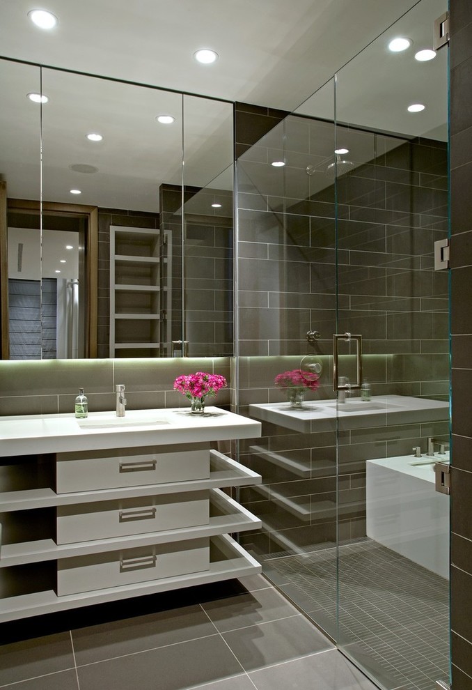 Contemporary wet room bathroom in San Francisco with white cabinets, grey tiles, a console sink, grey floors and a hinged door.