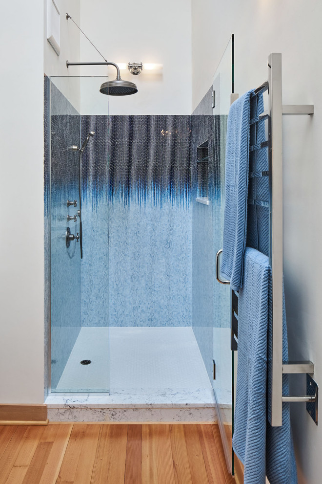 Medium sized urban ensuite bathroom in Portland with recessed-panel cabinets, blue cabinets, an alcove shower, a one-piece toilet, white walls, medium hardwood flooring, a submerged sink, marble worktops, brown floors, a hinged door, multi-coloured worktops, a wall niche, double sinks and exposed beams.