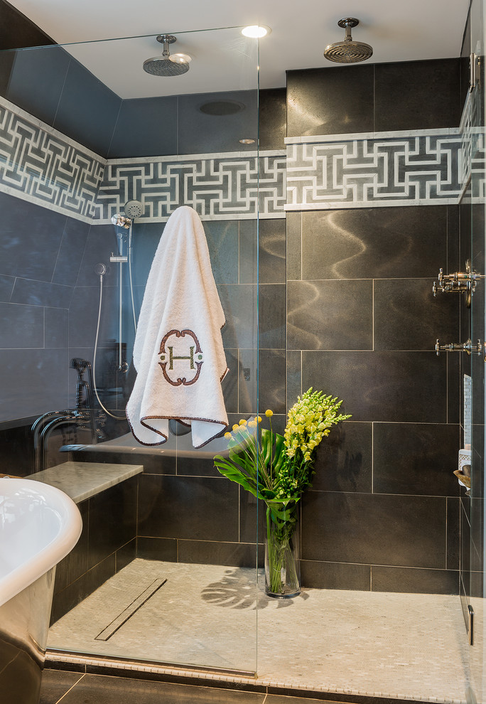 Photo of an industrial bathroom in Boston with an alcove shower and black tiles.