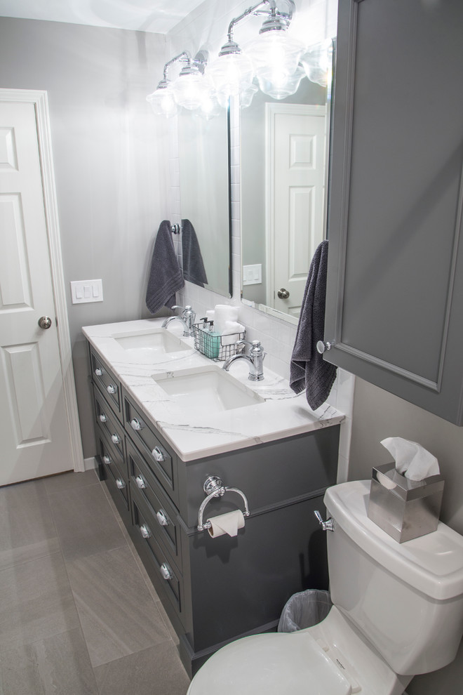 Example of a small urban white tile and subway tile porcelain tile bathroom design in Chicago with furniture-like cabinets, gray cabinets, a two-piece toilet, gray walls, an undermount sink and quartz countertops