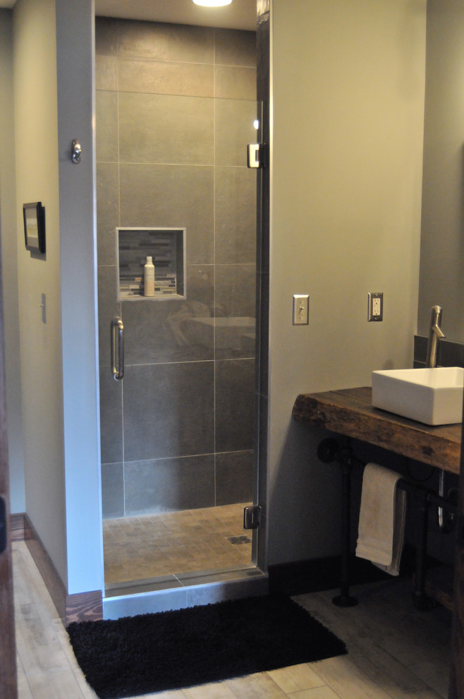 Modelo de cuarto de baño industrial con bañera encastrada, baldosas y/o azulejos grises, baldosas y/o azulejos de cerámica y suelo de baldosas de cerámica