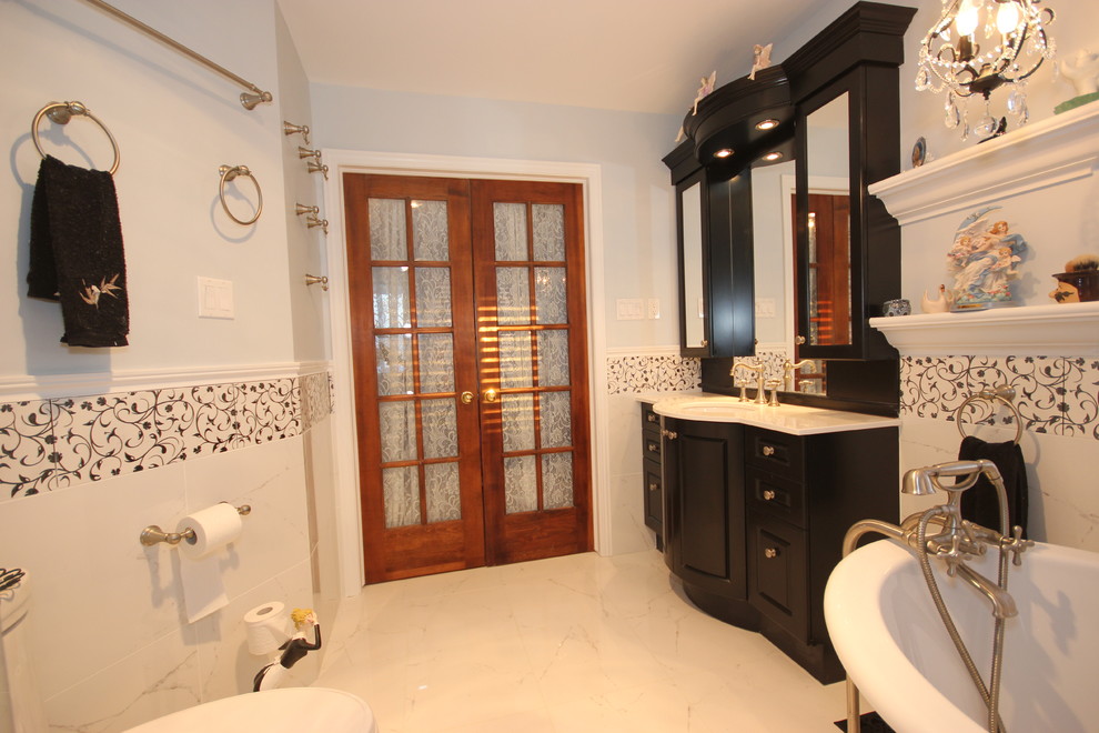 На фото: ванная комната в классическом стиле с врезной раковиной, фасадами с утопленной филенкой, темными деревянными фасадами, столешницей из кварцита, ванной на ножках, белой плиткой и керамогранитной плиткой с