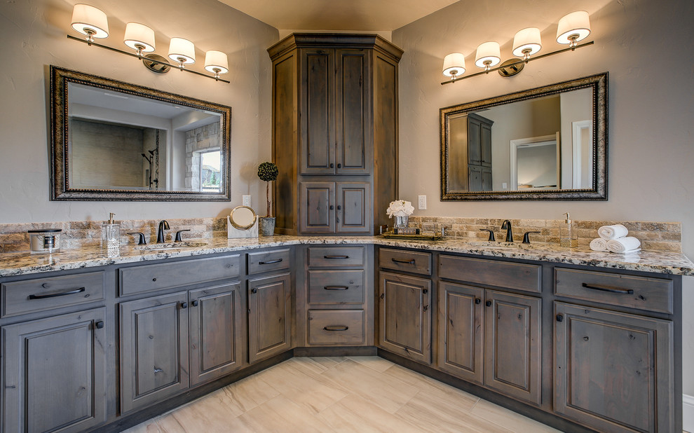 Inspiration for a mid-sized transitional master beige tile and porcelain tile travertine floor alcove shower remodel in Denver with raised-panel cabinets, medium tone wood cabinets, beige walls, an undermount sink and granite countertops