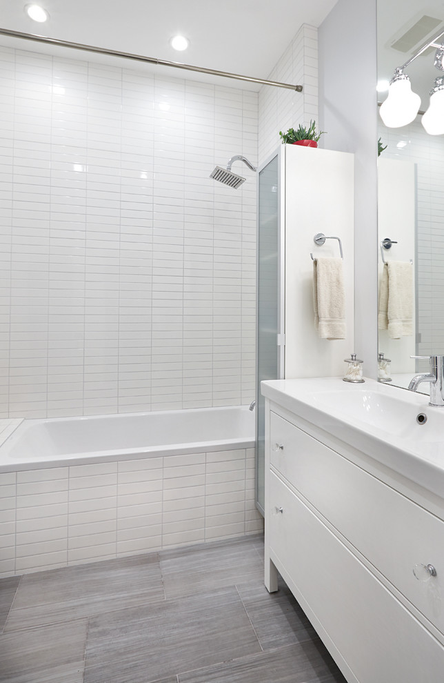 Bathroom - small modern master gray tile and ceramic tile porcelain tile bathroom idea in San Francisco with an integrated sink, recessed-panel cabinets, white cabinets, a one-piece toilet and gray walls