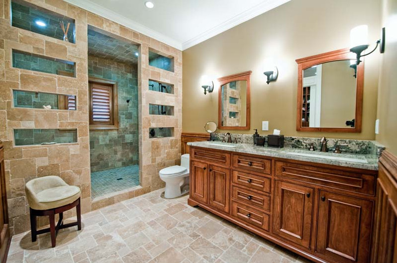 Example of a mid-sized arts and crafts master white tile and stone tile travertine floor bathroom design in Jacksonville with beaded inset cabinets, medium tone wood cabinets, a one-piece toilet, beige walls, an undermount sink and granite countertops