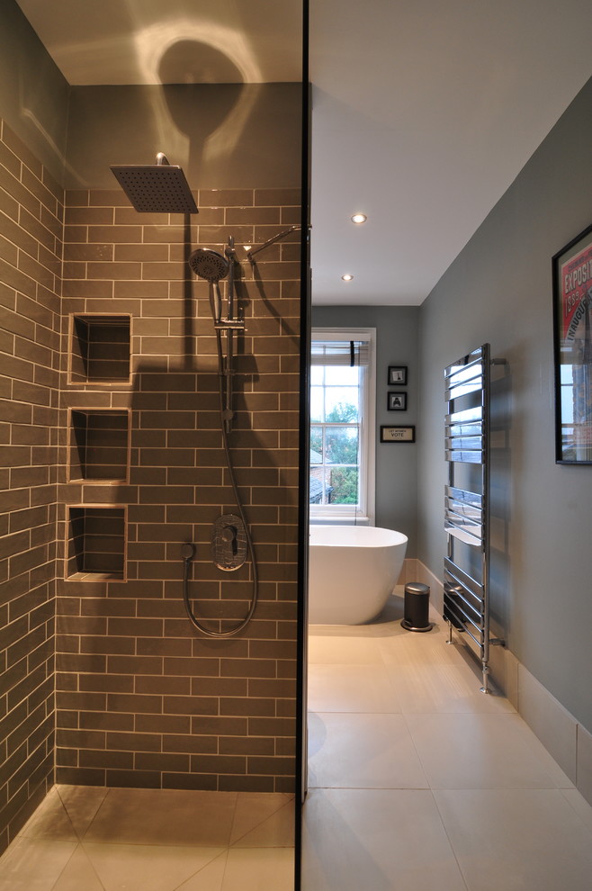 This is an example of a large traditional family bathroom in Other with shaker cabinets, blue cabinets, a freestanding bath, a walk-in shower, a one-piece toilet, blue walls, porcelain flooring, a built-in sink, laminate worktops, beige floors and an open shower.