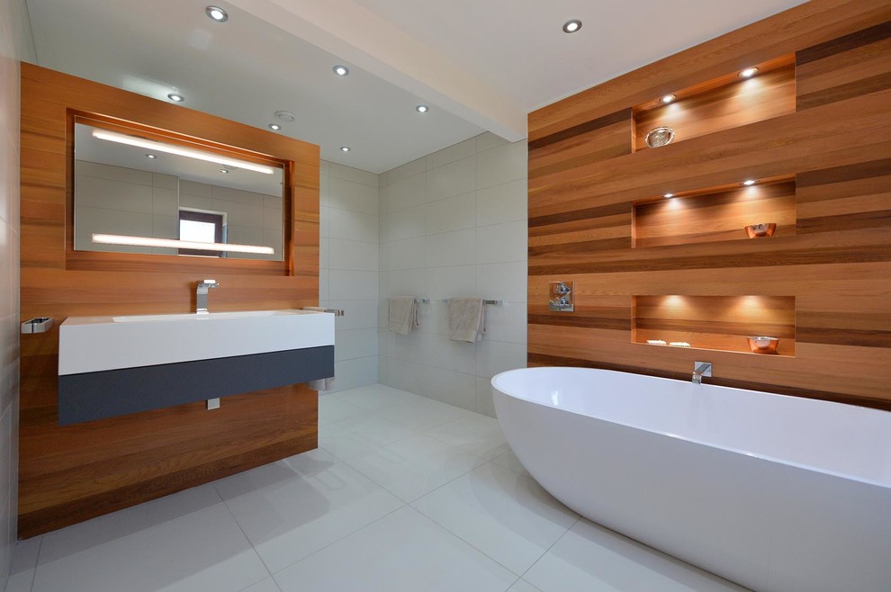 Design ideas for a contemporary bathroom in Other with light wood cabinets, a freestanding bath, white walls and a wall-mounted sink.