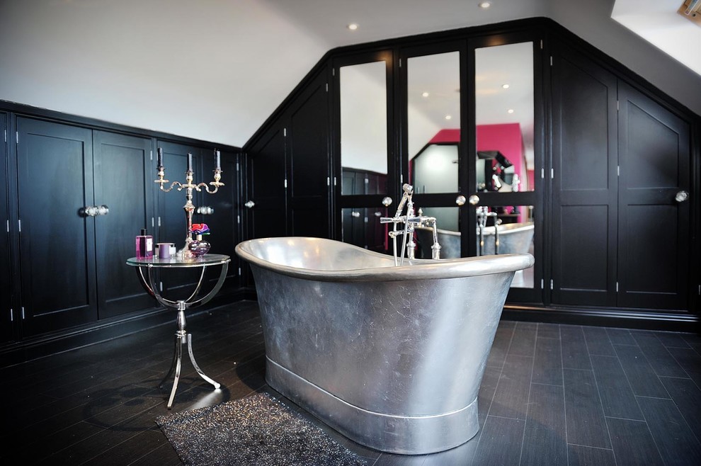 Photo of a contemporary bathroom in Other with glass-front cabinets, black cabinets, a freestanding bath, grey tiles and white walls.