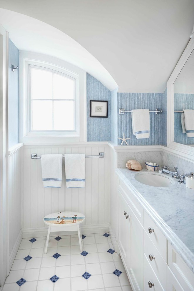Claw-foot bathtub - mid-sized coastal 3/4 white tile ceramic tile claw-foot bathtub idea in Other with a drop-in sink, flat-panel cabinets, white cabinets and blue walls
