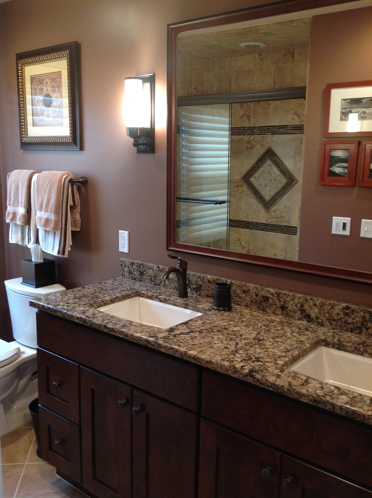 Inspiration for a small timeless beige tile and ceramic tile porcelain tile bathroom remodel in Newark with an undermount sink, shaker cabinets, dark wood cabinets, granite countertops, a one-piece toilet and brown walls