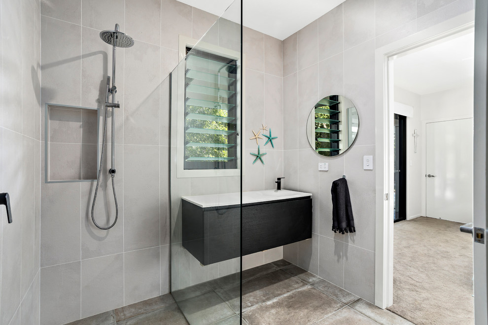 Design ideas for a small nautical shower room bathroom in Other with black cabinets, a corner shower, grey tiles, an open shower, white worktops, cement tiles, a built-in sink, solid surface worktops, beige walls, ceramic flooring, beige floors and flat-panel cabinets.