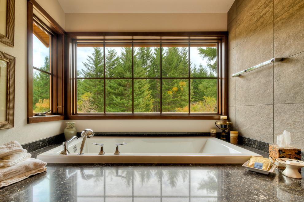 This is an example of a large rustic ensuite bathroom in Seattle with beige walls, dark wood cabinets, granite worktops, an alcove bath, brown tiles, porcelain tiles and porcelain flooring.