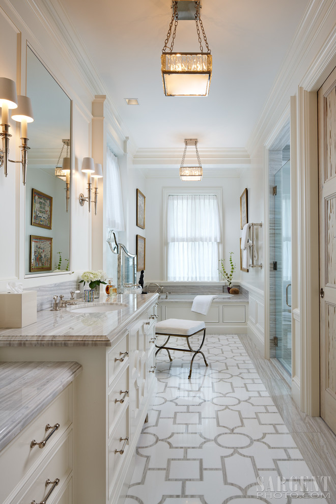Mid-sized elegant master beige tile and mosaic tile mosaic tile floor and white floor bathroom photo in Miami with marble countertops, recessed-panel cabinets, white cabinets, white walls, an undermount sink and a hinged shower door