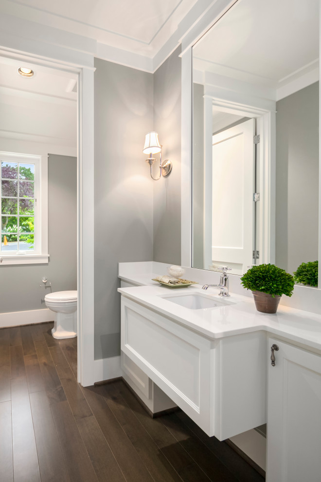 Bathroom - mid-sized transitional 3/4 brown floor and single-sink bathroom idea in Seattle with shaker cabinets, white cabinets, a two-piece toilet, gray walls, an undermount sink, white countertops and a floating vanity