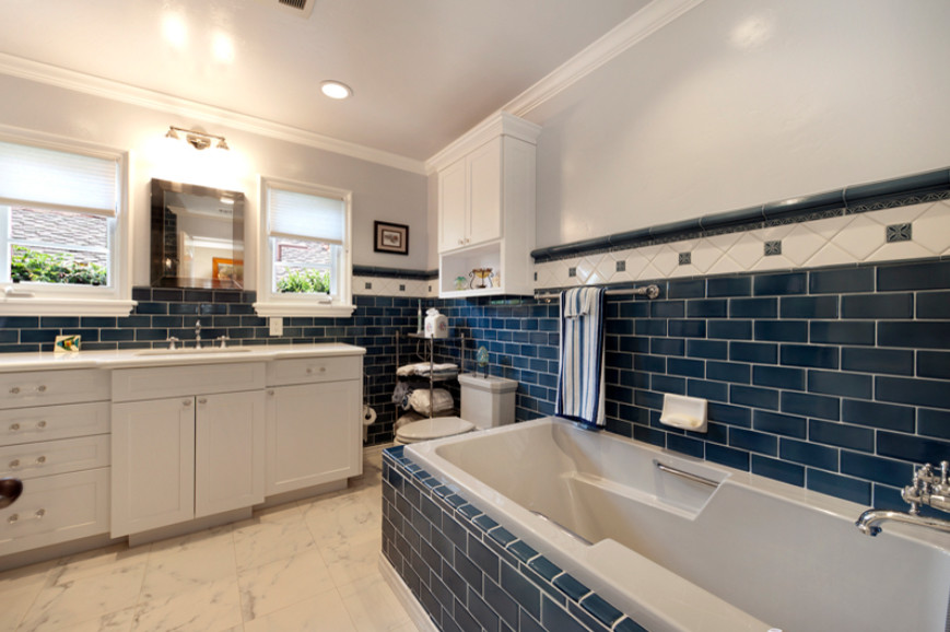 Medium sized traditional ensuite bathroom in Orange County with recessed-panel cabinets, light wood cabinets, a built-in bath, a corner shower, a one-piece toilet, blue tiles, ceramic tiles, yellow walls, porcelain flooring, a submerged sink and engineered stone worktops.