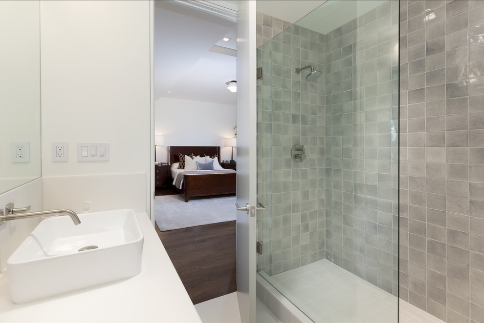 Inspiration for a medium sized contemporary ensuite bathroom in San Francisco with flat-panel cabinets, white cabinets, a double shower, a one-piece toilet, white tiles, stone tiles, white walls, ceramic flooring, a built-in sink and engineered stone worktops.