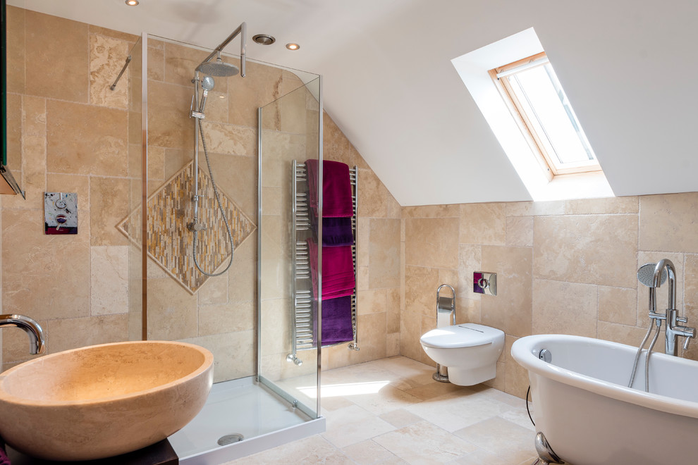 This is an example of a medium sized mediterranean bathroom in Other with a freestanding bath, a wall mounted toilet, beige tiles, beige walls, a vessel sink, beige floors and black worktops.