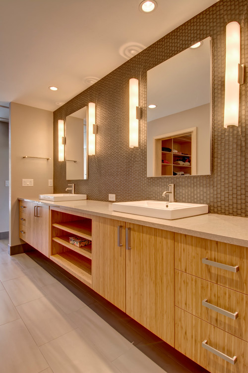 Modern bathroom vanity with bamboo-style cabinets, dual vessel sinks, and sleek storage drawers – a sustainable choice when choosing bathroom cabinets
