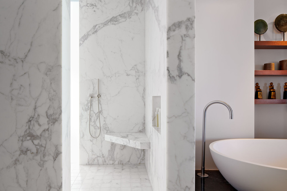 This is an example of a modern bathroom in San Francisco with marble tiles, a wall niche and a shower bench.