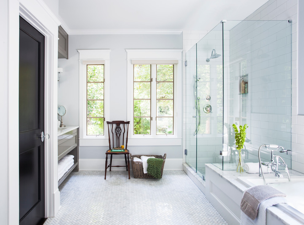 Photo of a classic bathroom in Atlanta with a submerged sink, recessed-panel cabinets, grey cabinets, a built-in bath, a corner shower, white tiles, metro tiles and white floors.