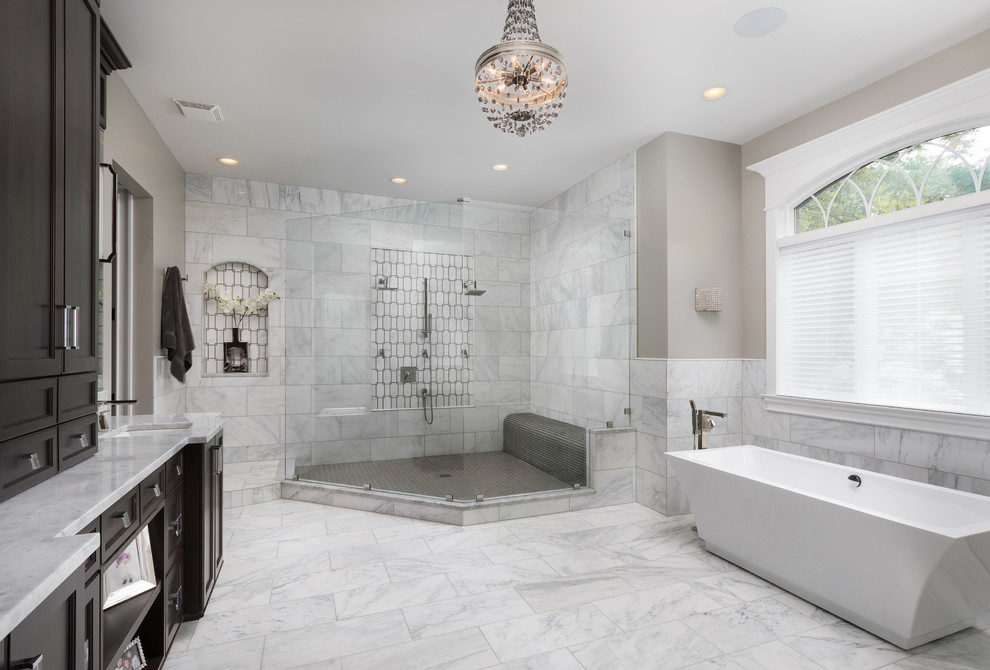 Inspiration for a large transitional master white tile and marble tile marble floor bathroom remodel in Chicago with raised-panel cabinets, white cabinets, a one-piece toilet, beige walls, an undermount sink and marble countertops