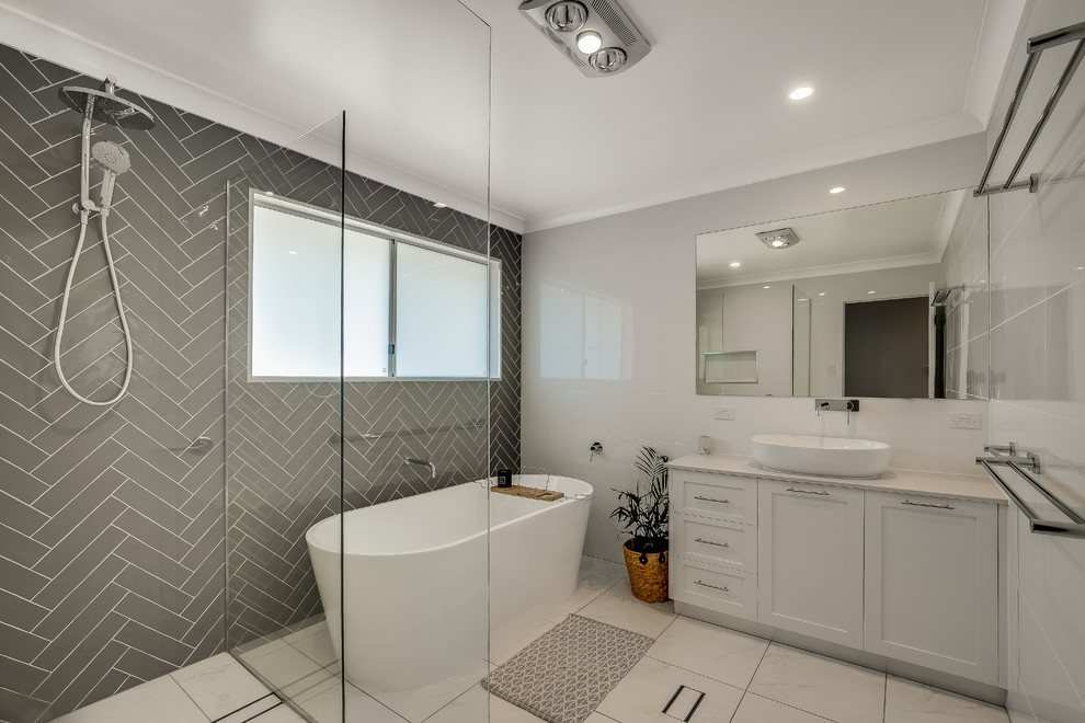 Inspiration for a classic ensuite bathroom in Other with a freestanding bath, shaker cabinets, white cabinets, a corner shower, grey walls, a vessel sink, beige floors, an open shower and beige worktops.