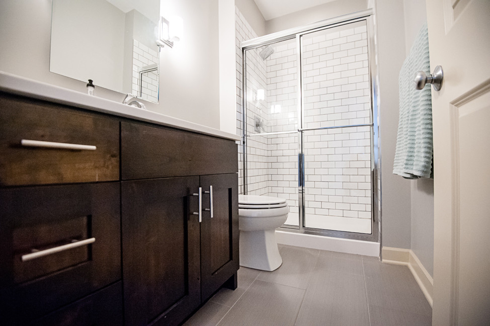 На фото: главная ванная комната среднего размера в классическом стиле с фасадами в стиле шейкер, темными деревянными фасадами, угловым душем, унитазом-моноблоком, серыми стенами, полом из винила и столешницей из кварцита с
