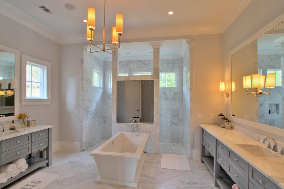 Photo of a classic bathroom in Other with a submerged sink, grey cabinets, marble worktops, a freestanding bath, a built-in shower, stone tiles, grey walls and marble flooring.
