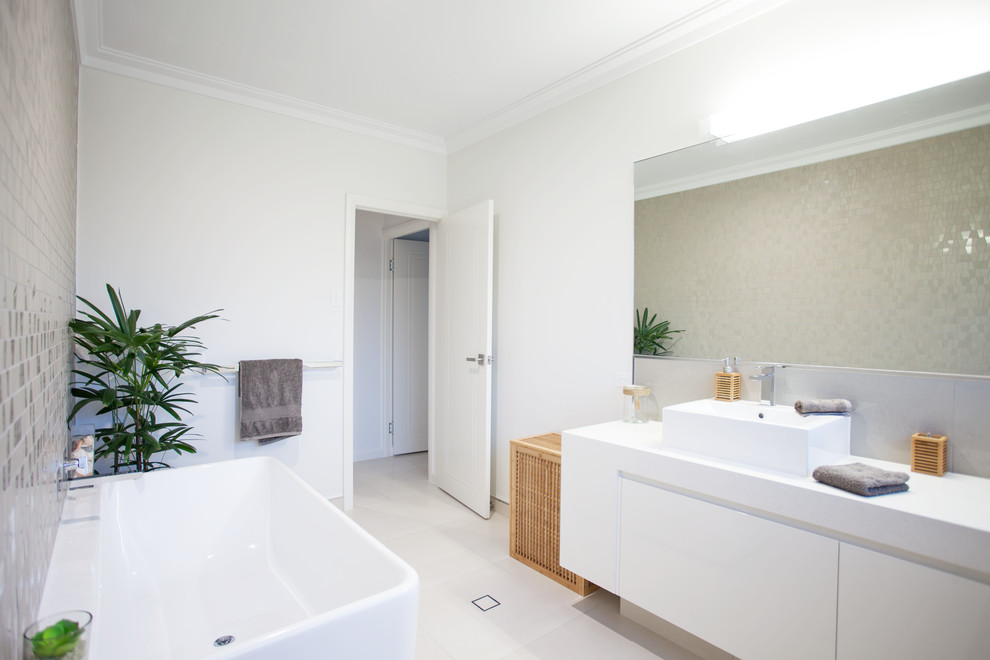 Exempel på ett stort modernt vit vitt badrum för barn, med ett fristående badkar, en öppen dusch, vita väggar, ett fristående handfat, släta luckor, vita skåp, beige kakel, keramikplattor, klinkergolv i keramik, granitbänkskiva, vitt golv och med dusch som är öppen