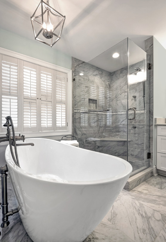 Example of a mid-sized beach style master gray tile and porcelain tile porcelain tile and gray floor bathroom design in Charleston with shaker cabinets, white cabinets, blue walls, an undermount sink, quartz countertops, a hinged shower door and gray countertops