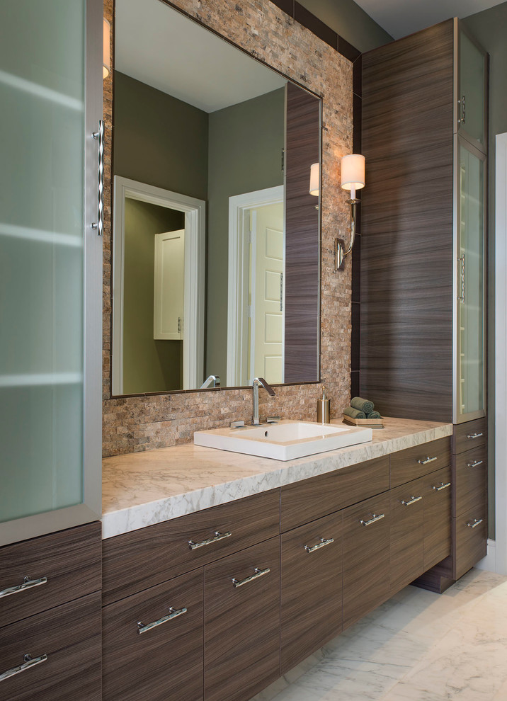 This is an example of a large contemporary ensuite bathroom in Dallas with a built-in sink, dark wood cabinets, marble worktops, a built-in bath, a double shower, a two-piece toilet, white tiles, stone slabs, green walls, marble flooring and flat-panel cabinets.